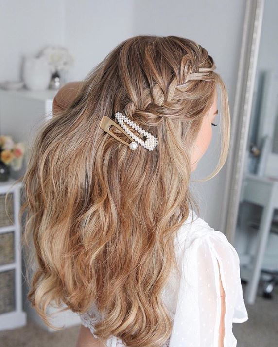 Blonde woman with long hair in a half-up fishtail braid