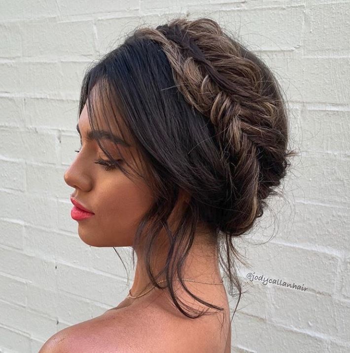 Bank holiday hairstyles: Woman with brown balayage wavy hair in fishtail milkmaid braids.