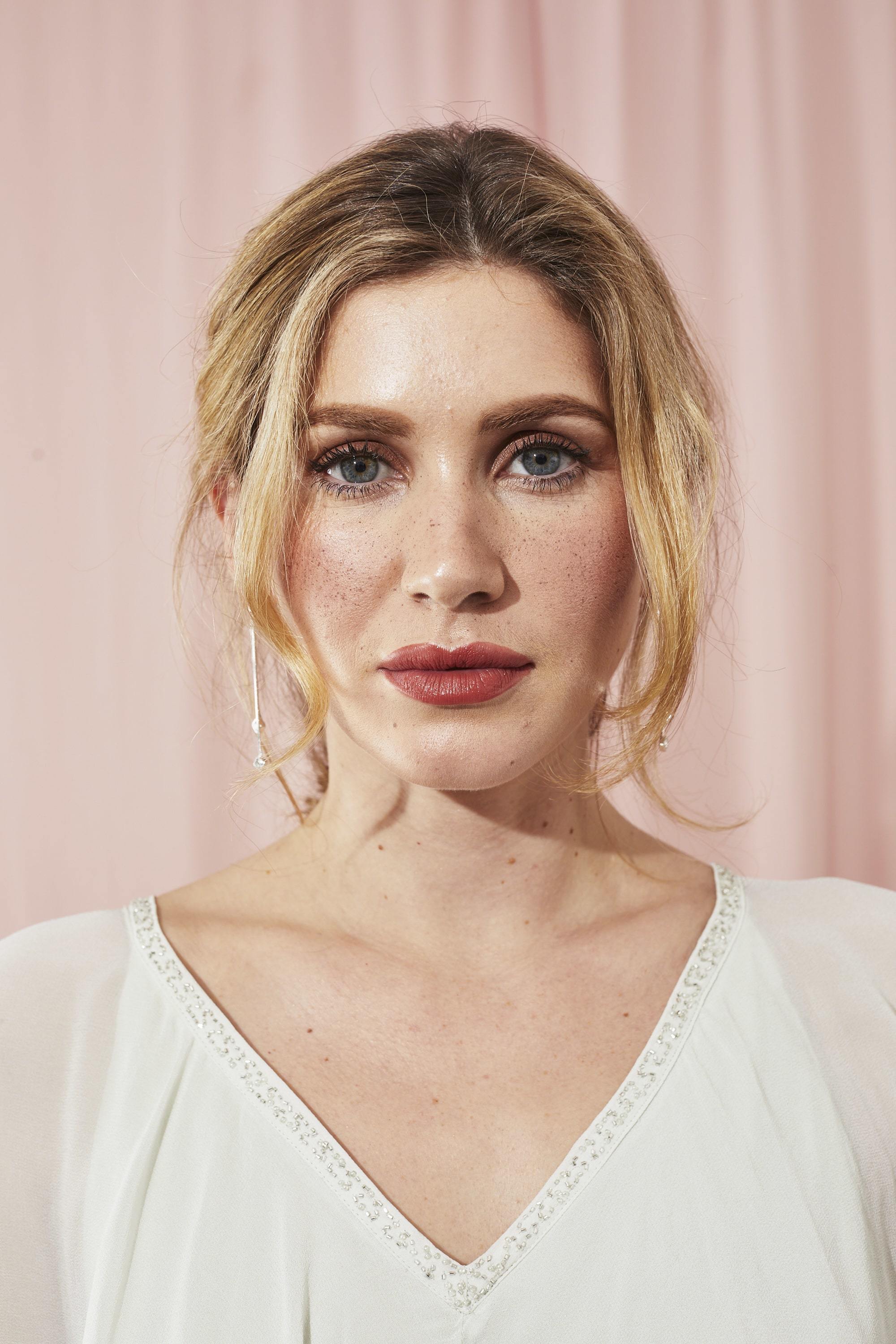 Woman with blonde hair styled into a loose tousled updo