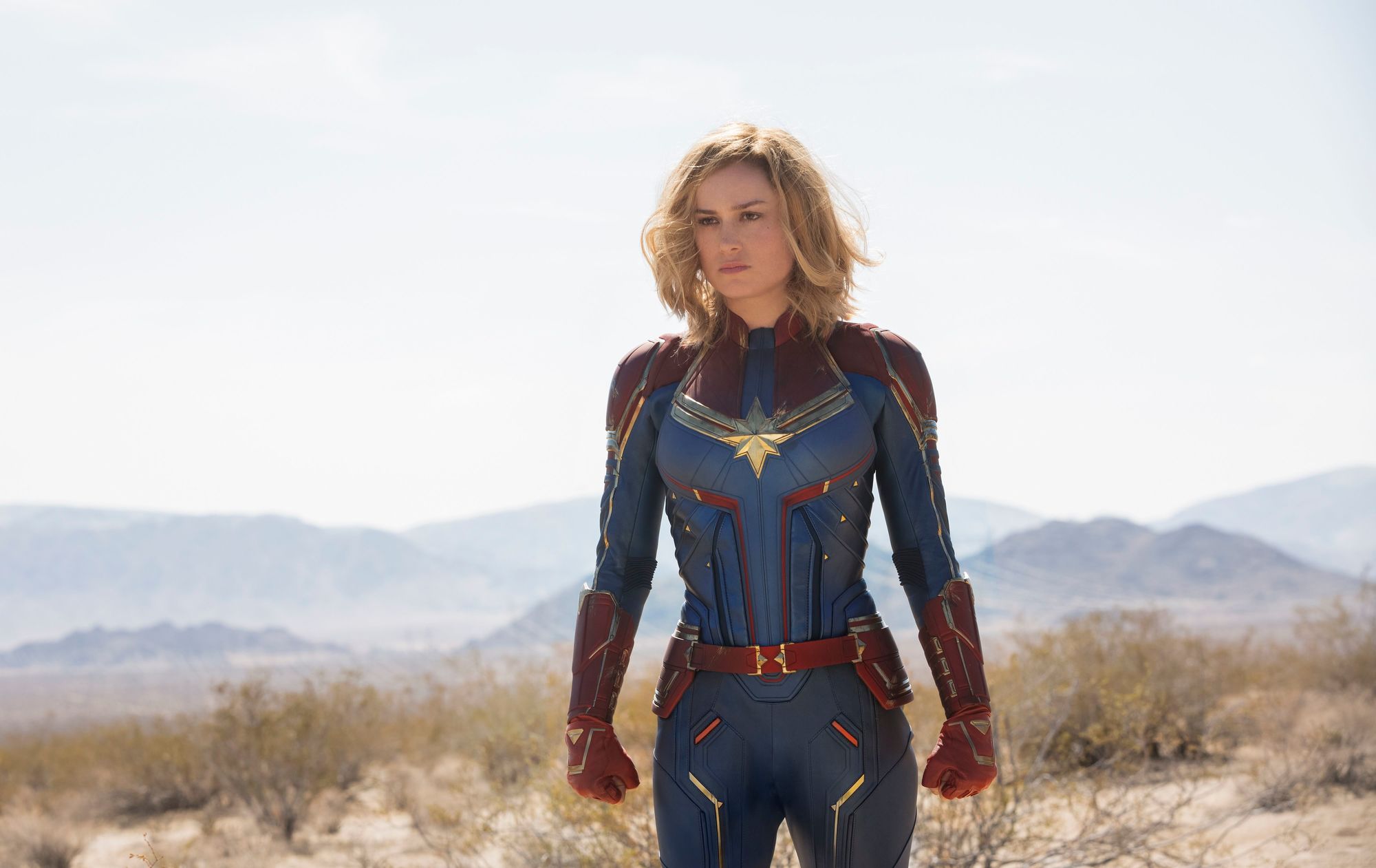 Marvel hairstyles: Brie Larson as Captain Marvel with long wavy blonde bob wearing superhero jumpsuit costume