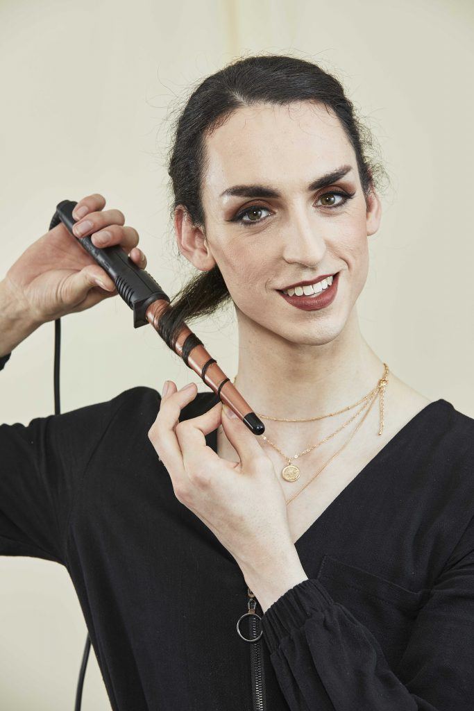 woman with sectioned hair curling her hair