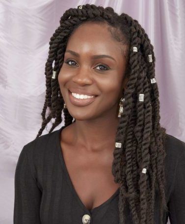 Braid hairstyles Photo of a woman with long twisted marley braids with hair cuffs, wearing a black top