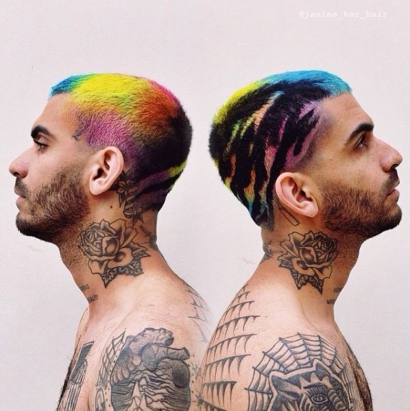 Two men back to back with tattoos and rainbow hair