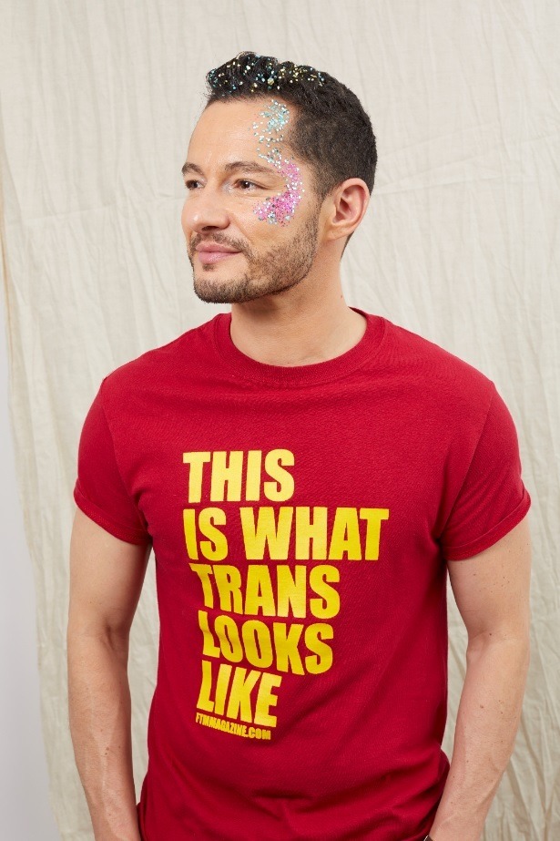 man with short brown hair with glitter in his hair and on his face