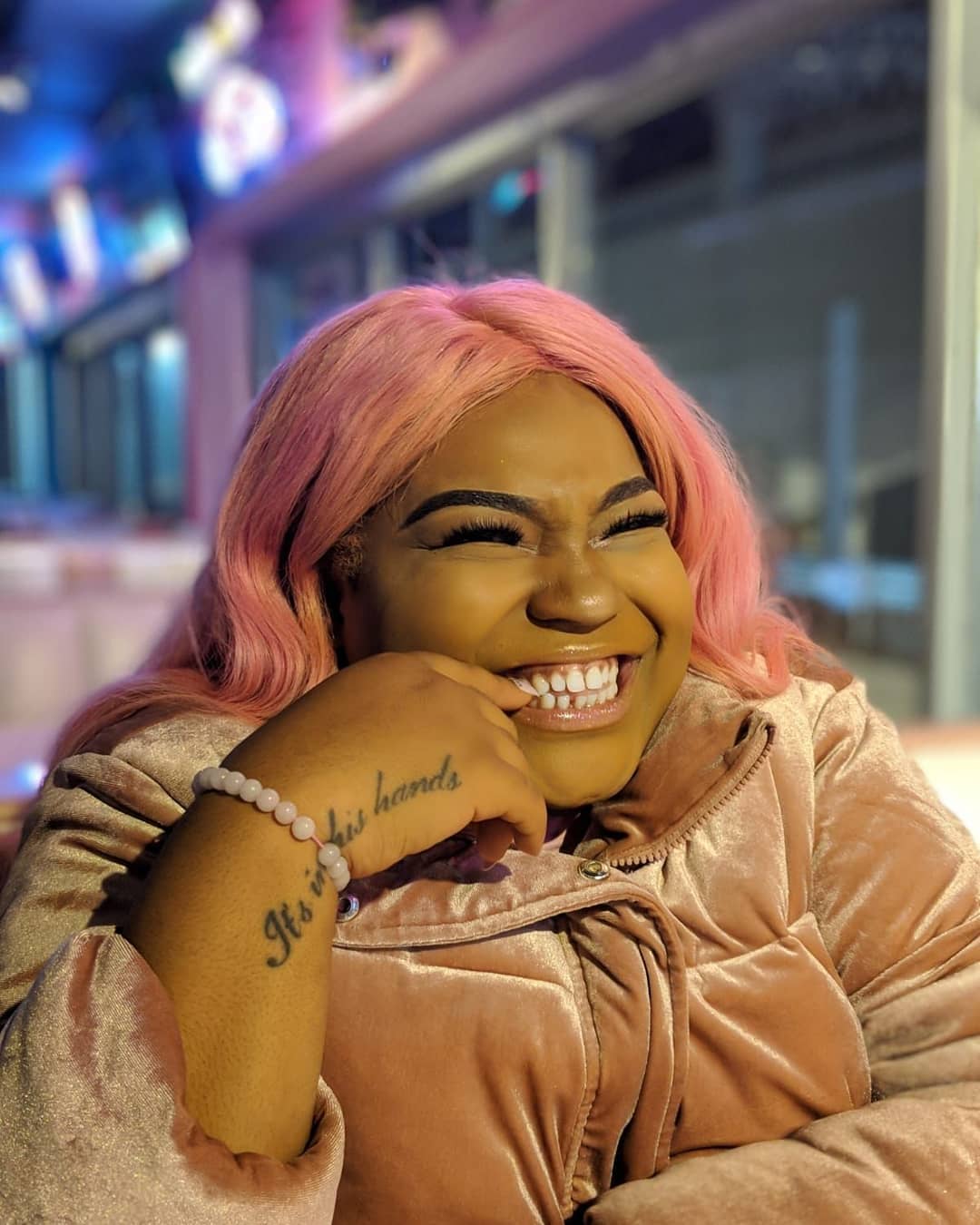 Smiling woman with pink hair