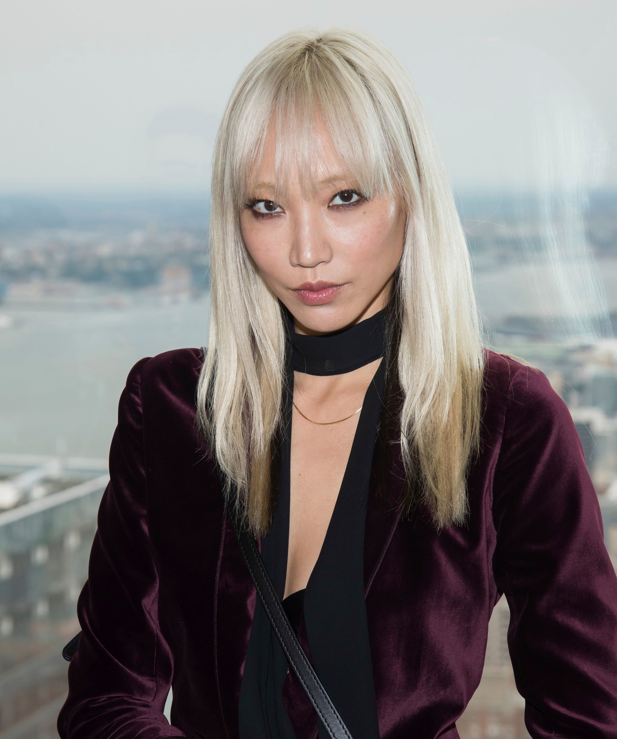Soo Joo Park with bleach blonde straight hair with bangs