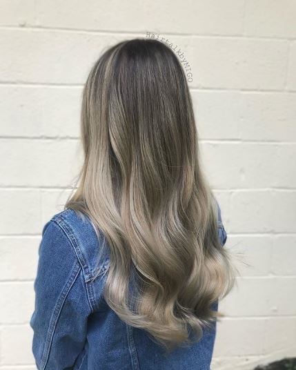 Woman with ash blonde wavy ombre hair