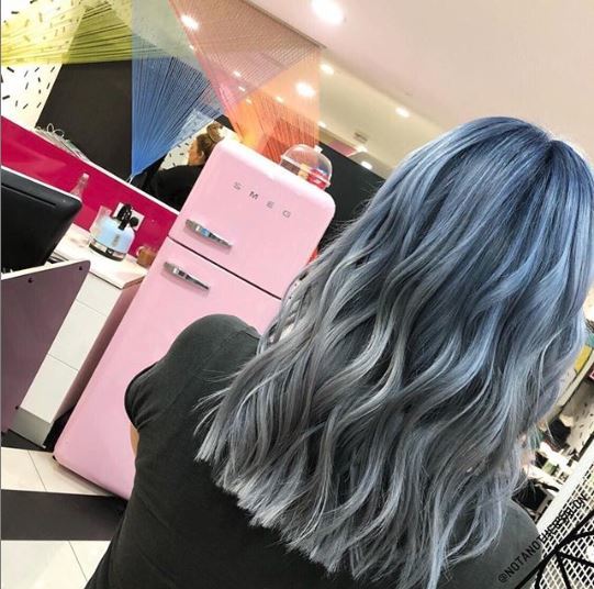 Woman with blue grey wavy ombre hair
