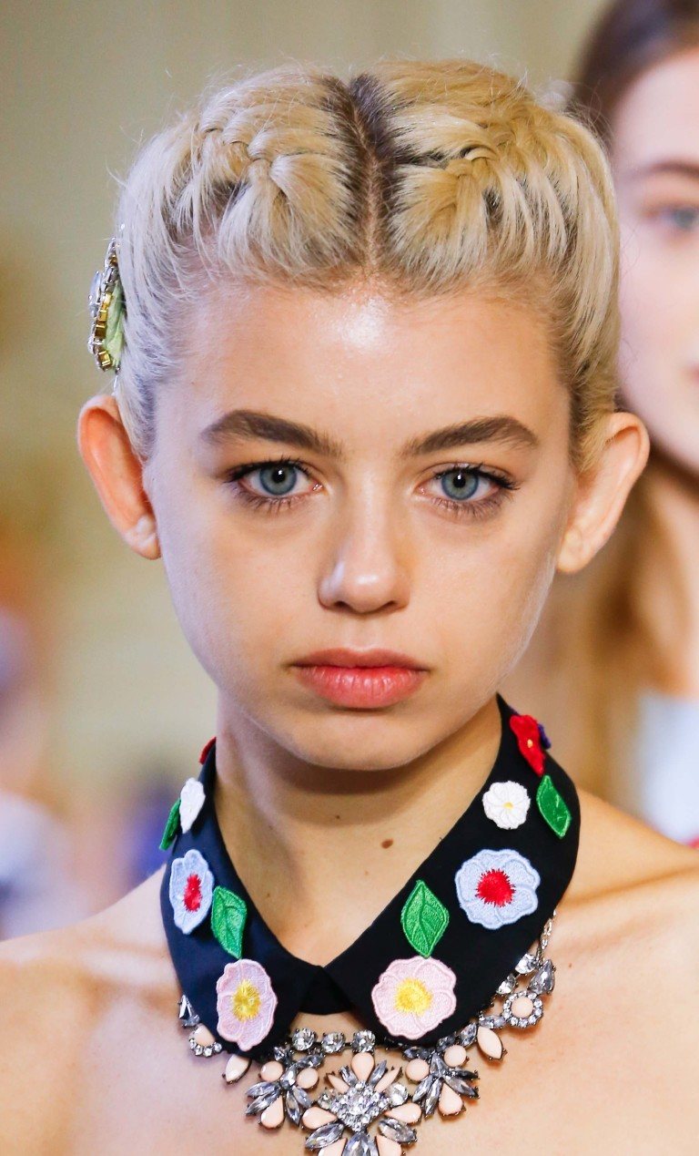 Model with blonde short hair in braids
