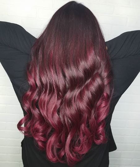 Woman with long brown and burgundy ombre hair