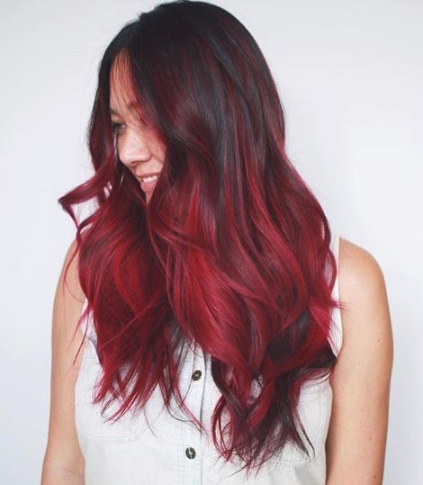 Woman with long burgundy red ombre hair