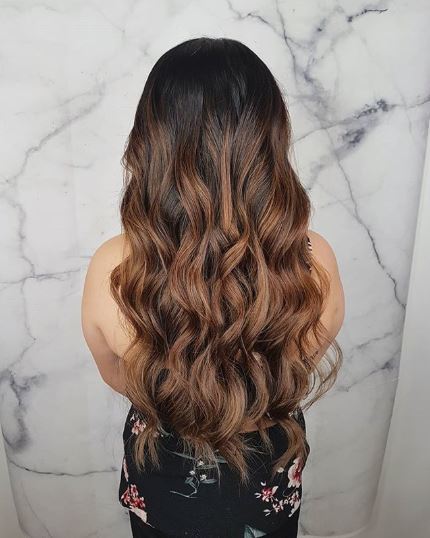 Woman with long wavy dark brown ombre hair