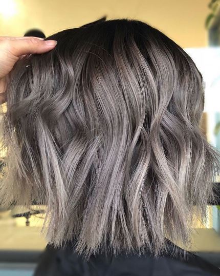 woman with wavy grey ombre shoulder length hair