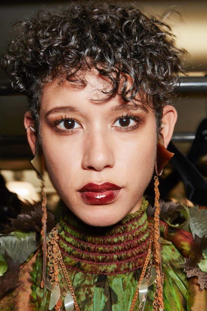 Woman with short curly hair pixie