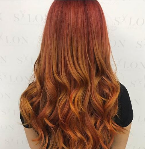 woman with long wavy orange ombre