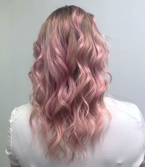 Woman with pastel pink ombre wavy hair