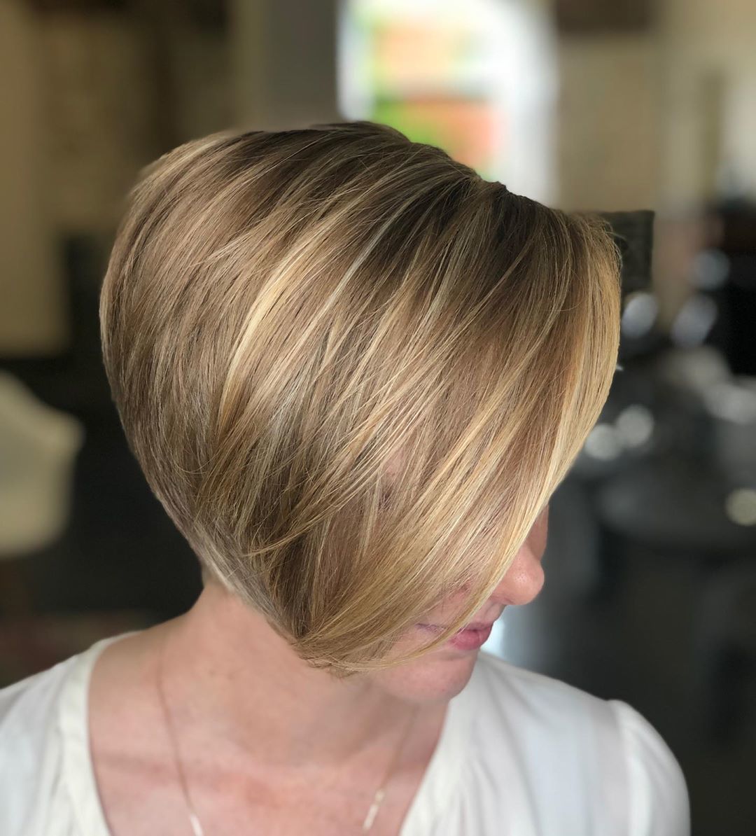 woman with dark blonde pixie haircut