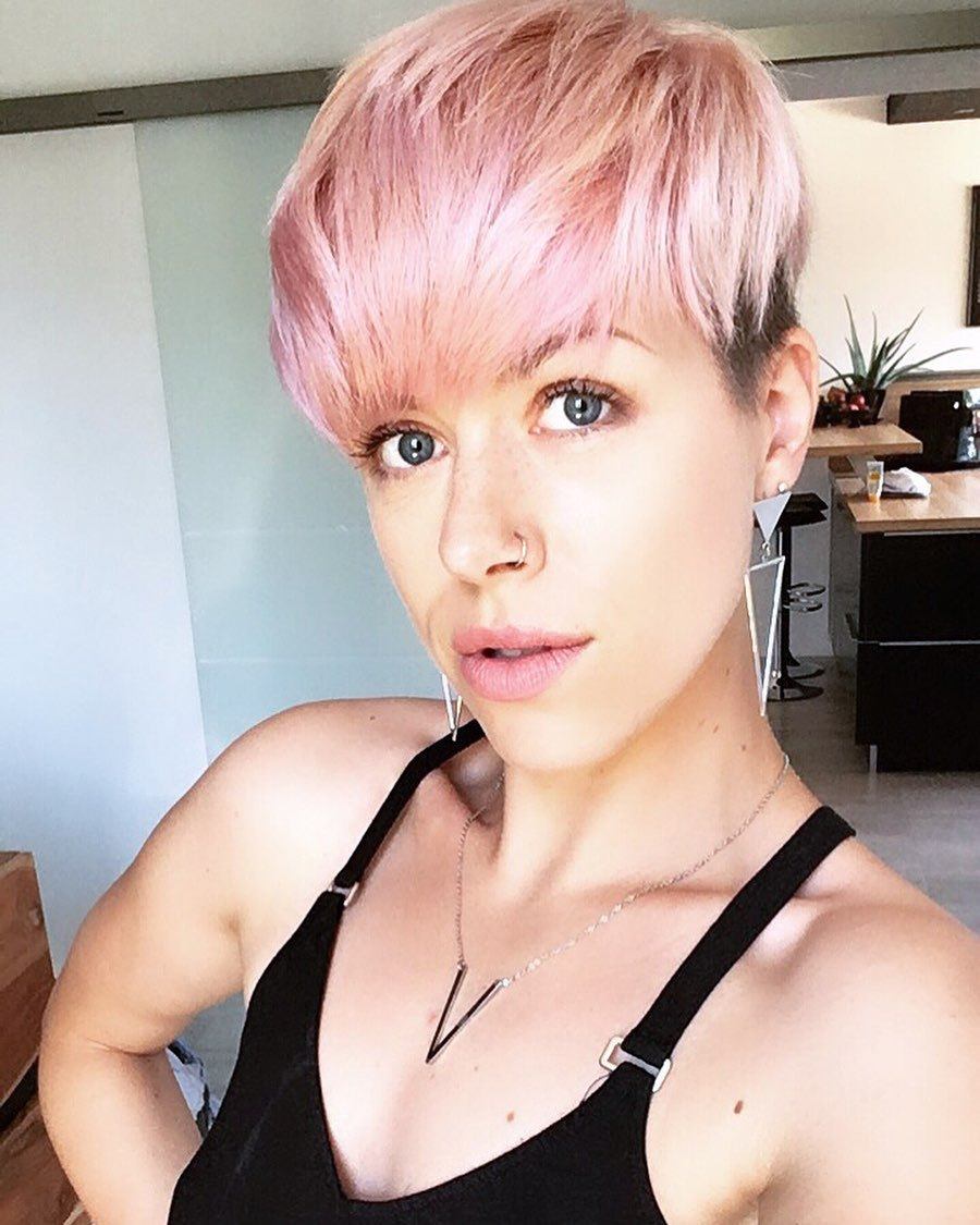 woman with a long face with a pink pixie cut hairstyle