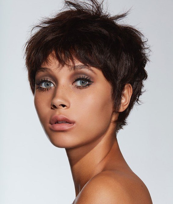 woman with dark brown messy 60s pixie haircut