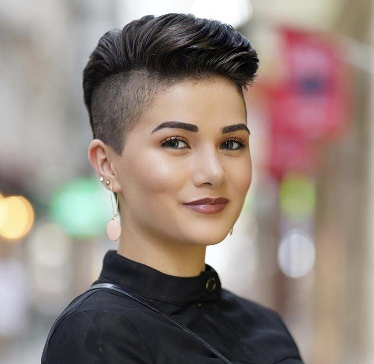 woman with a round face and swept back pixie with shaved side