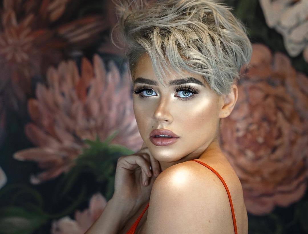 woman with silver blonde wavy pixie haircut