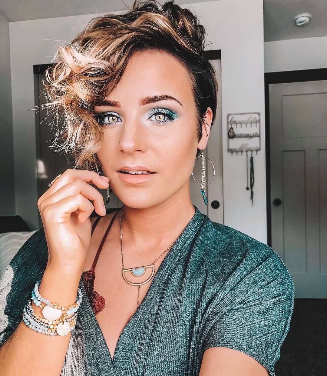 woman with dark brown to blonde pixie cut with bangs