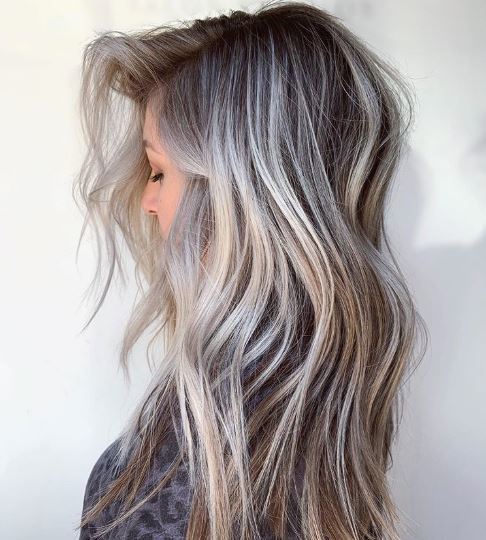 Woman with ash blonde highlighted wavy hair
