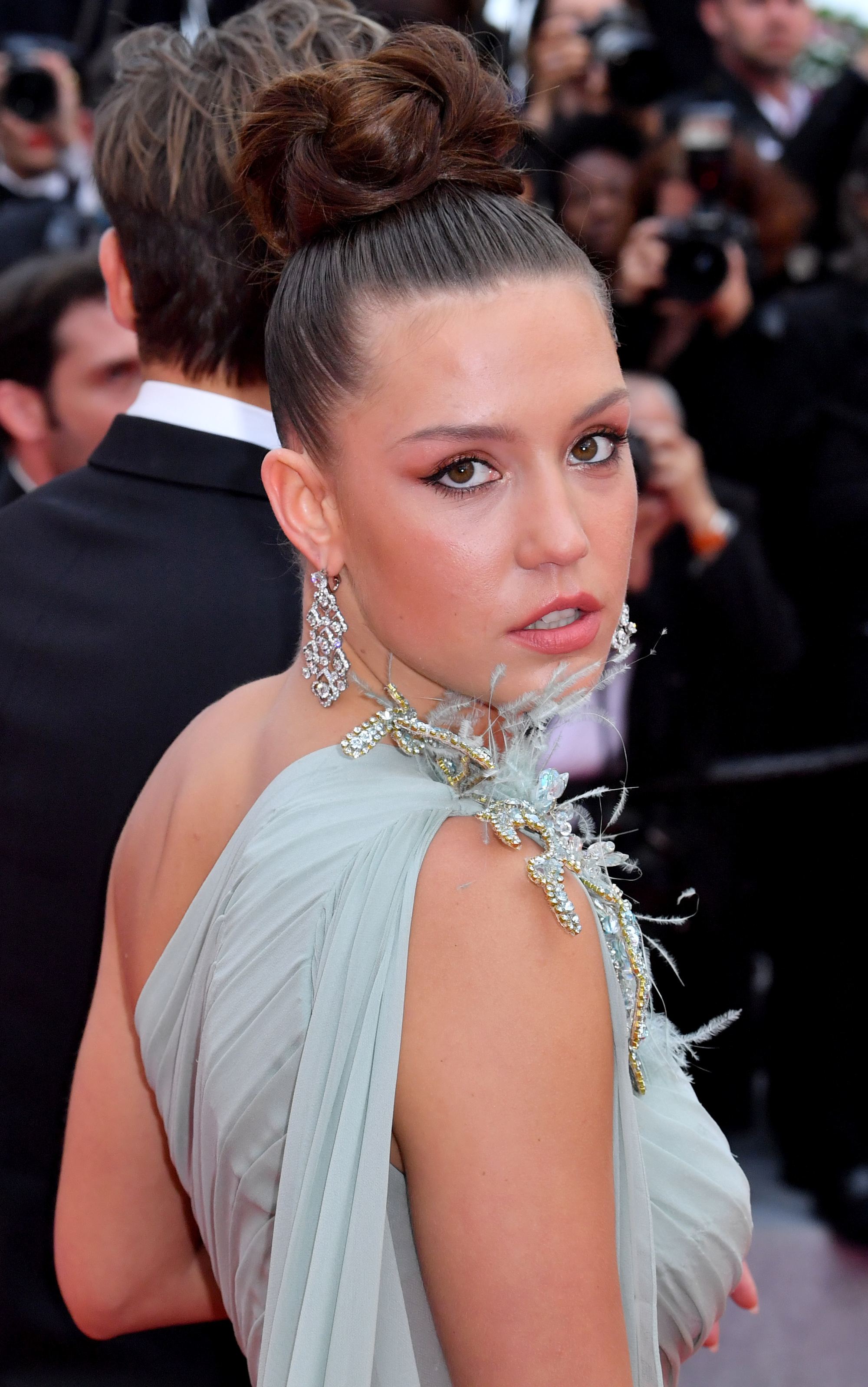 Woman with brown hair in high bun
