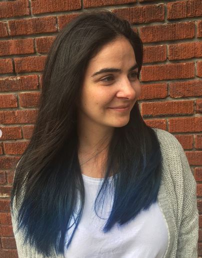 Woman with long dark brown hair with blue tips