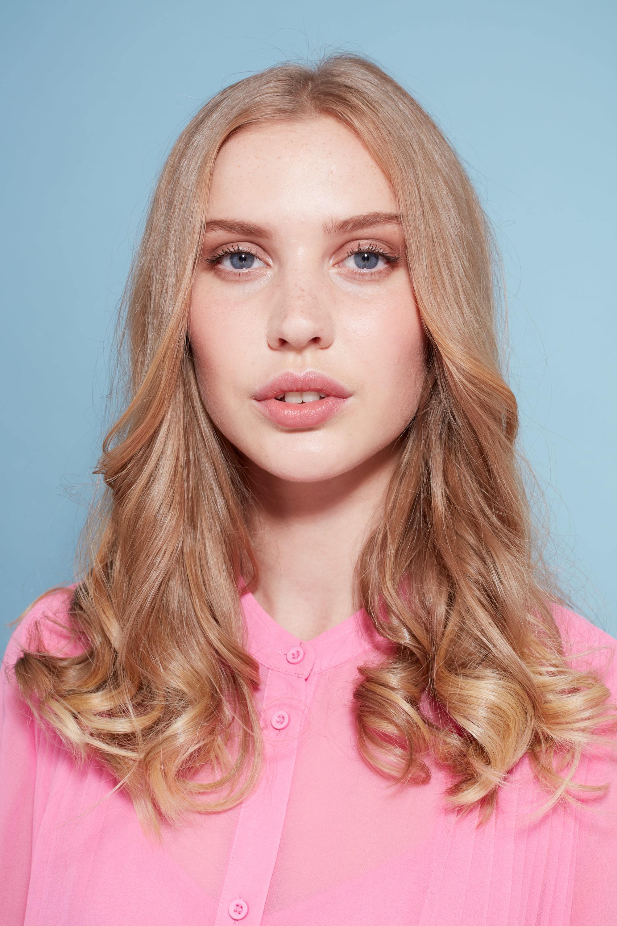 Blonde woman with shoulder length curly blow out hair