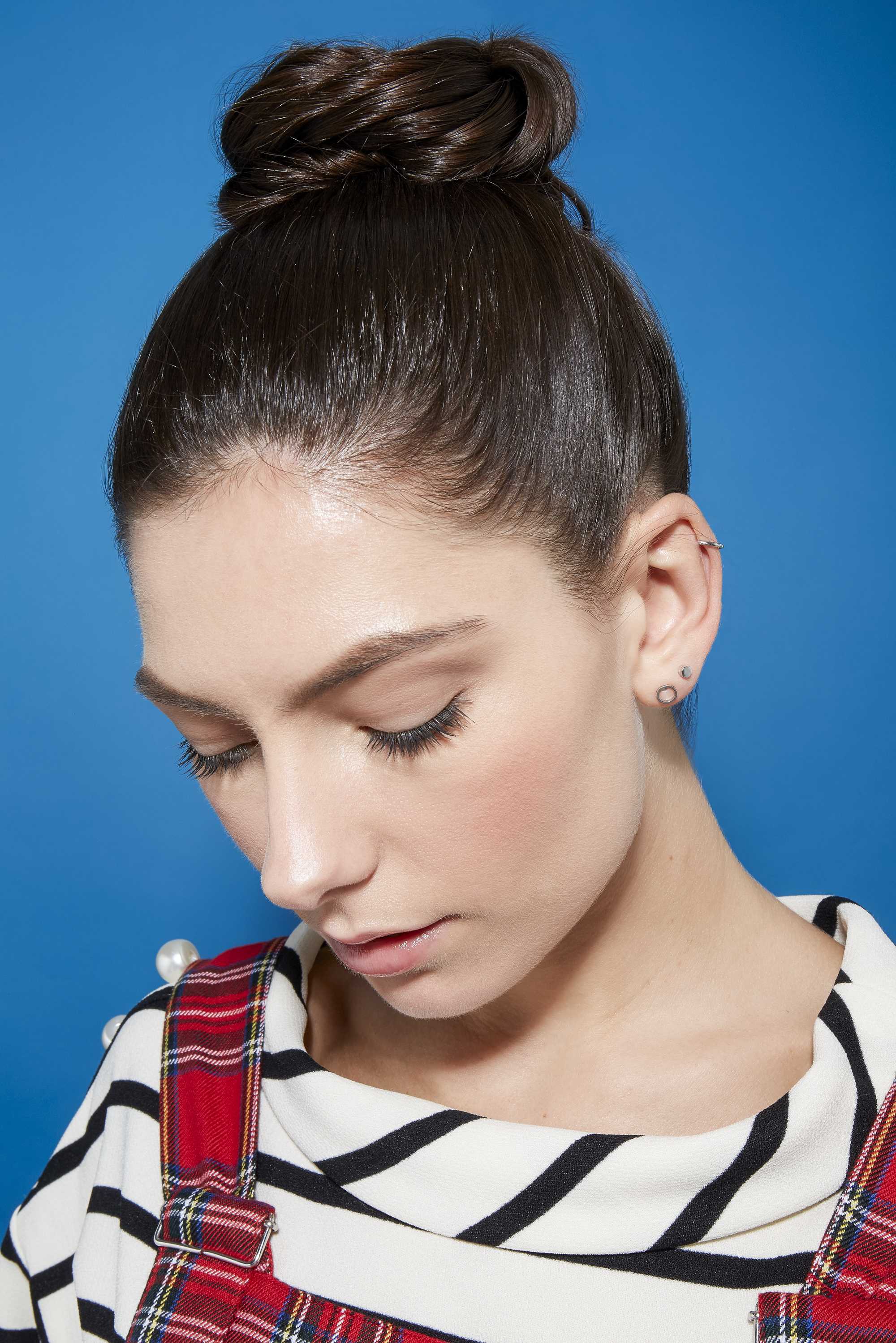 Brunette woman with hair in braided bun