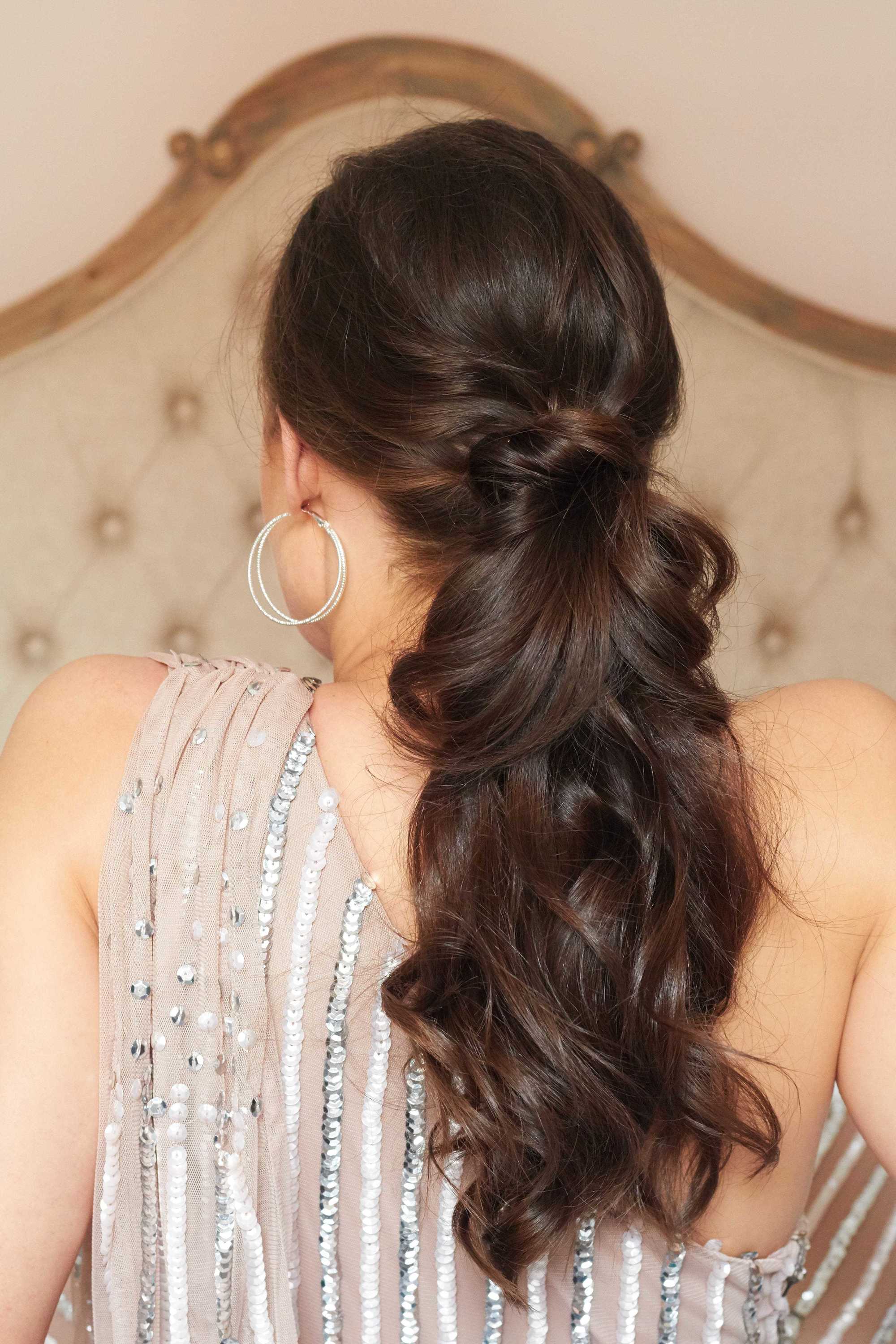 Brunette woman with a twisted curly ponytail