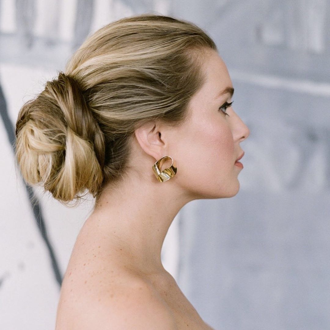 Woman with blonde hair in low bun