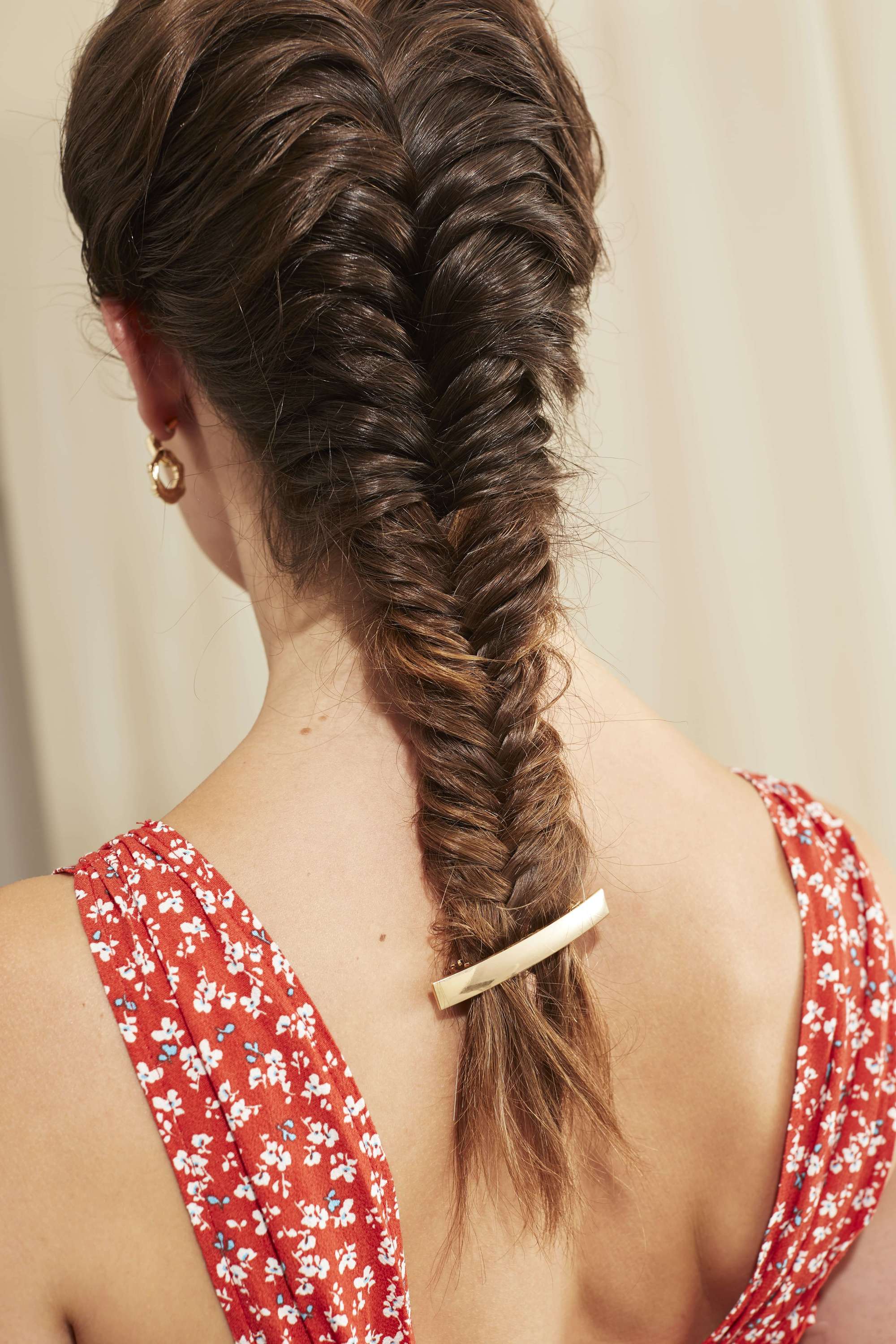 Fishtail braid on long brown hair