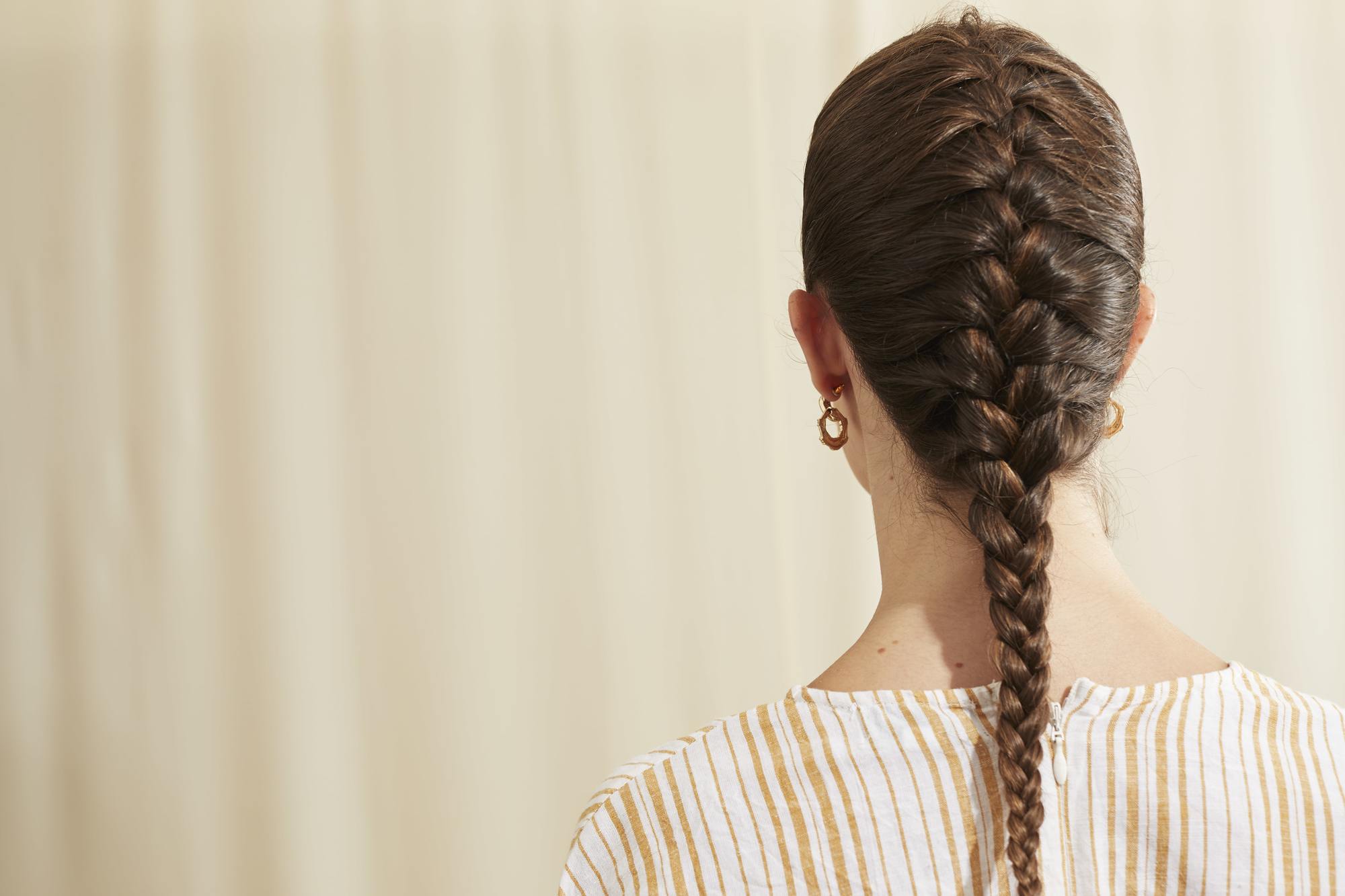 French braid on long brown hair