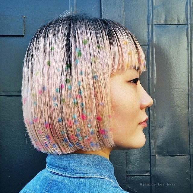 woman with pink bob with bangs with graffiti polka dots