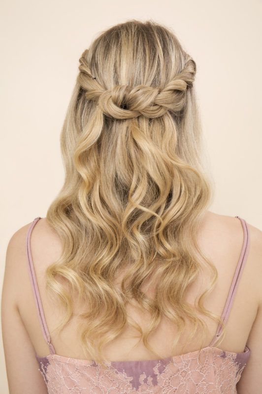 Blonde woman with wavy hair in a plaited half-up half-down