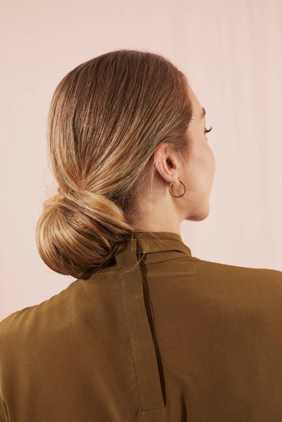 Woman with blonde hair in low chignon