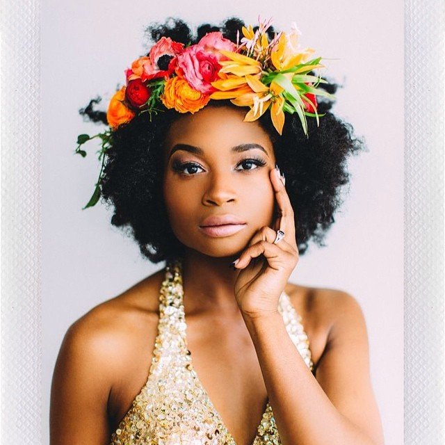 Woman with medium natural afro with flower crown