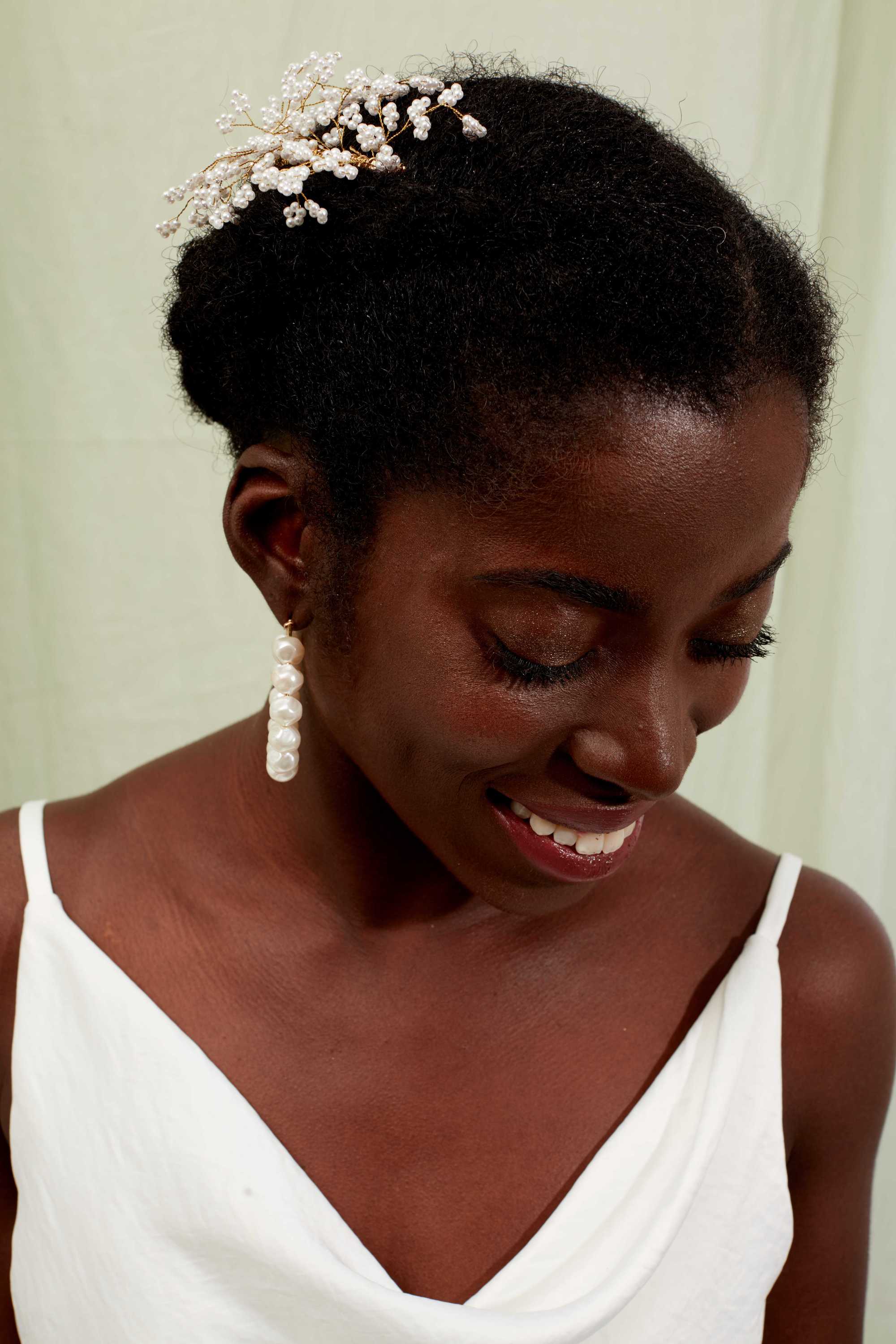Woman with natural low braided hair with hair pins in it