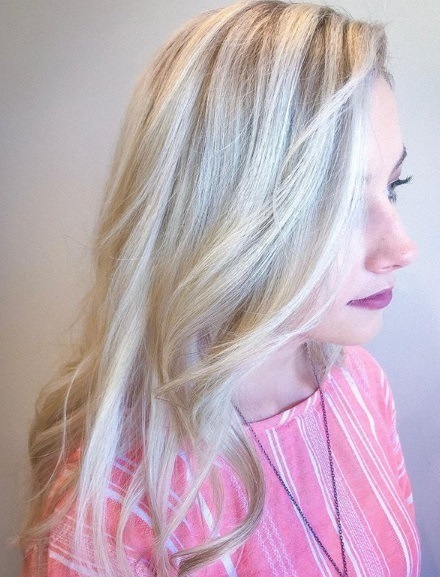 Woman with platinum blonde highlighted curly hair