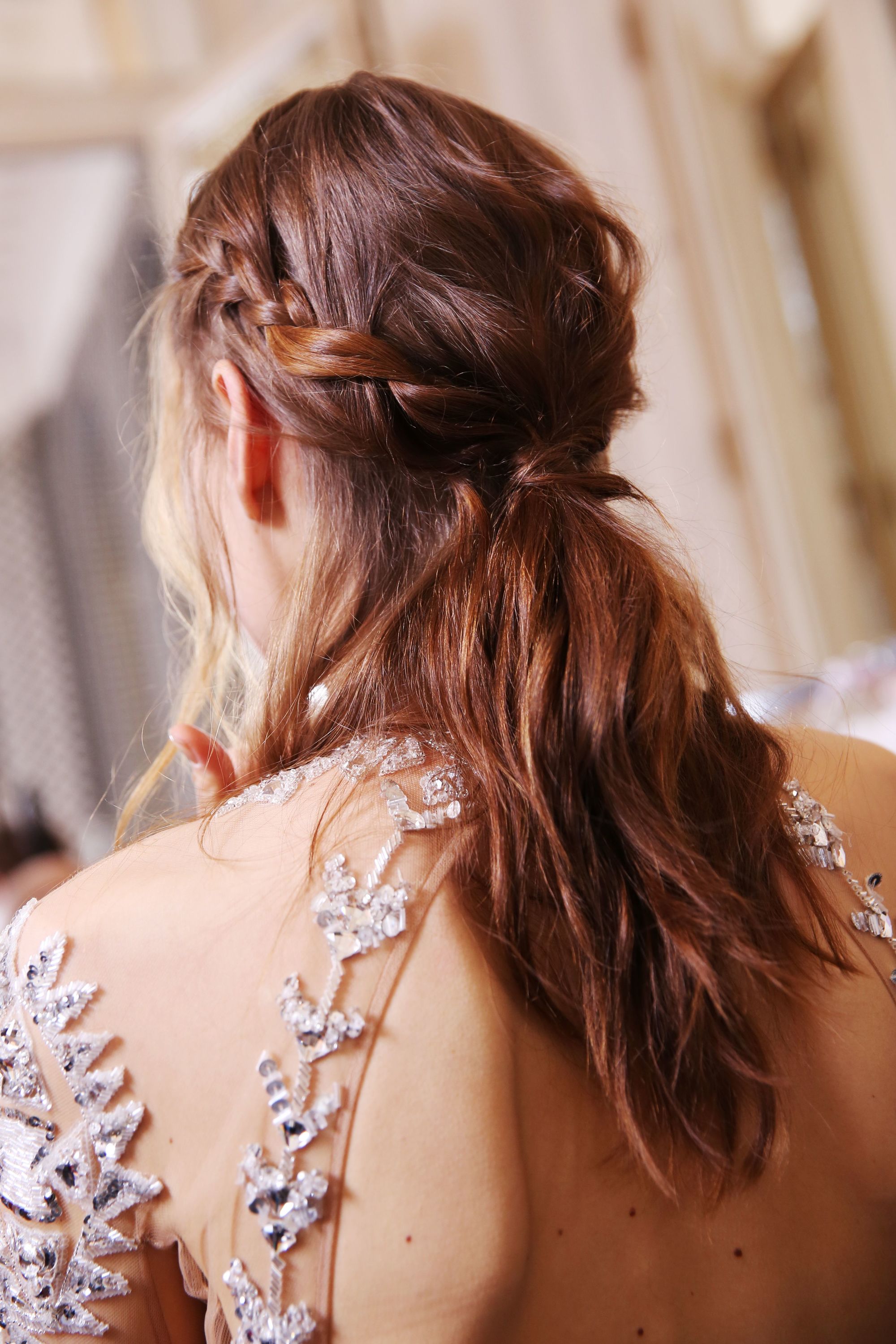 Brown hair in braided ponytail