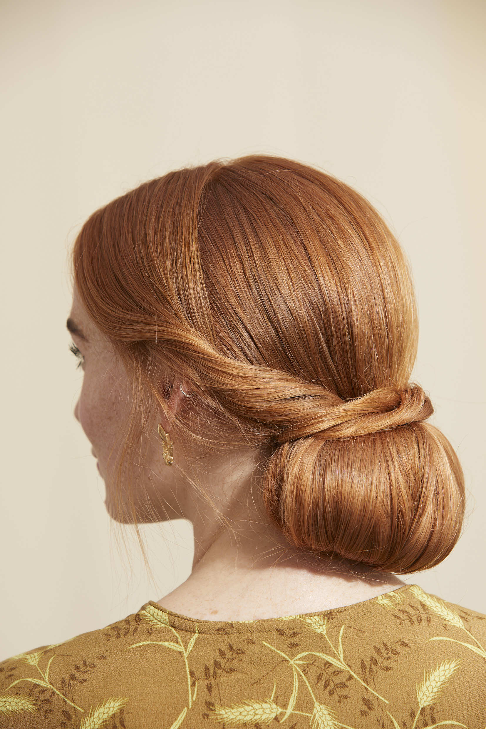 Woman with red hair in a twisted low chignon