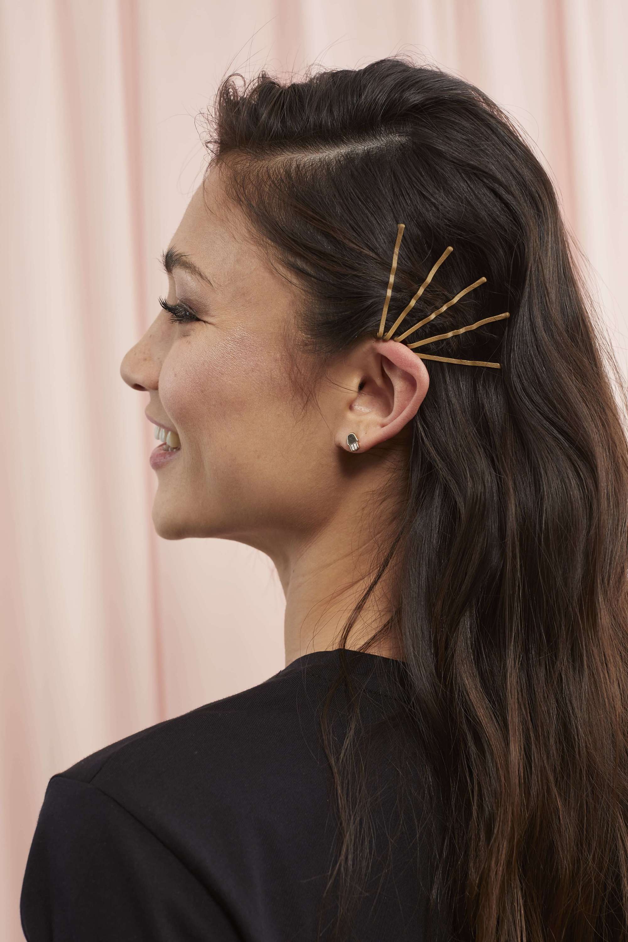 Woman with long brown hair and bobby pins