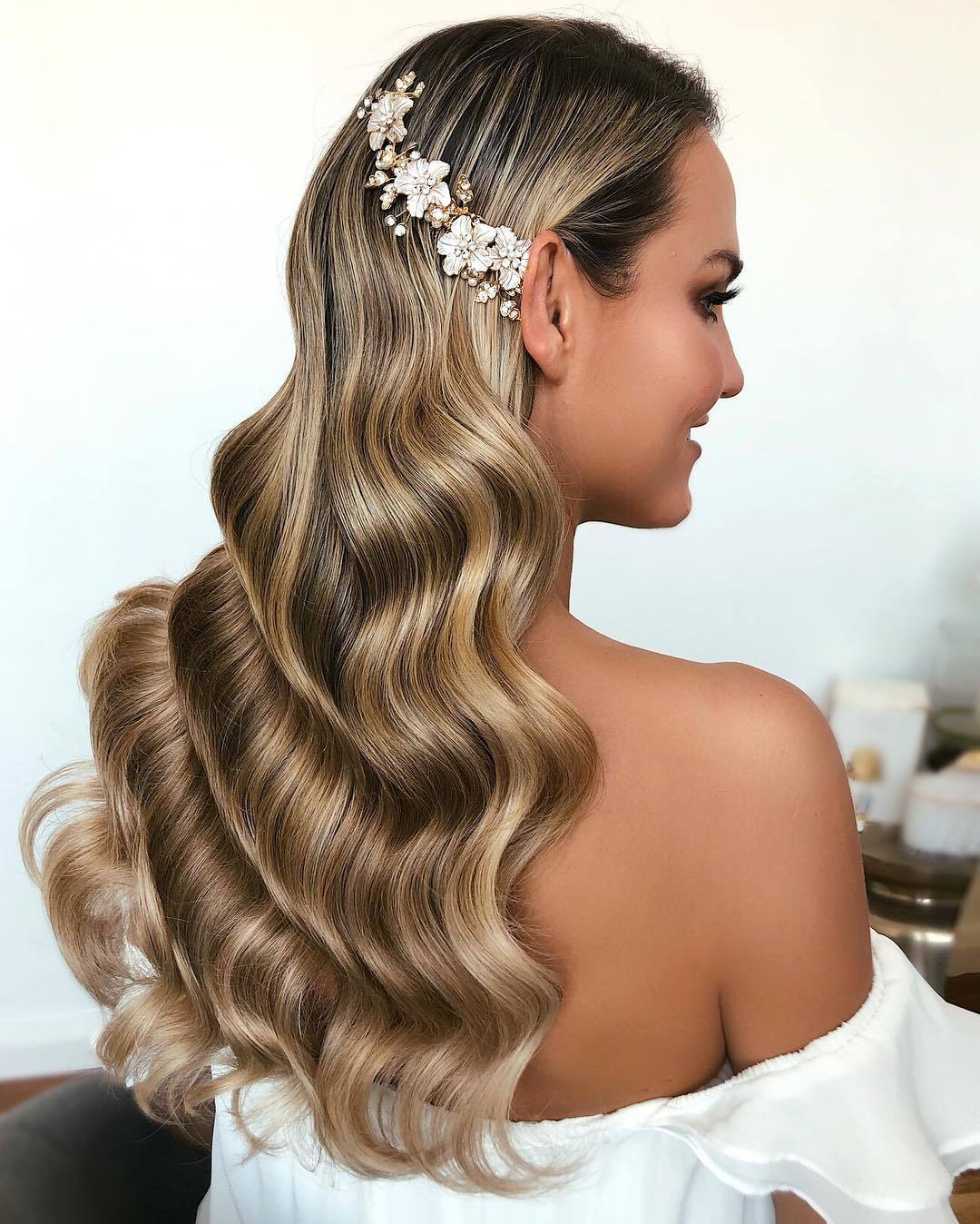 woman with long dark blonde hollywood waves with hair pins