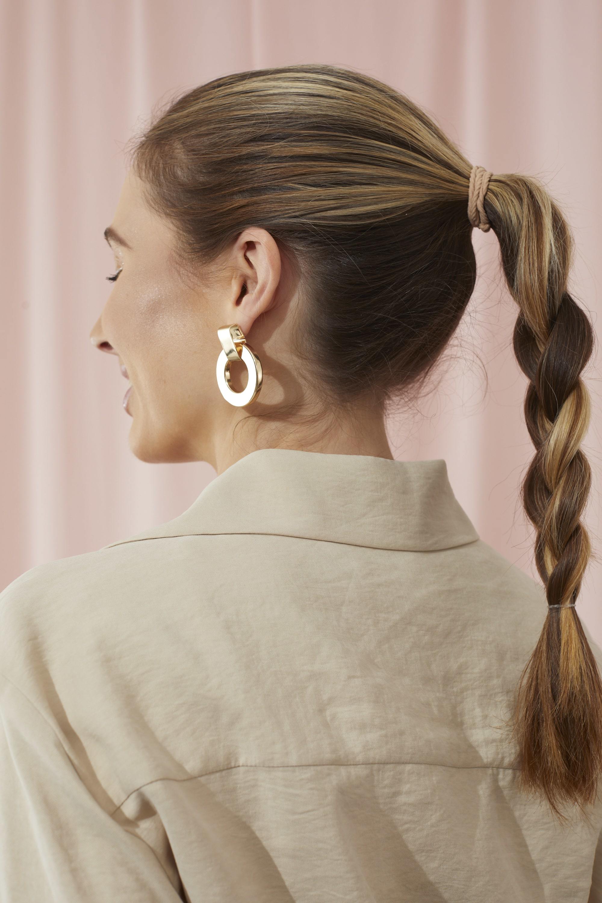 Woman with hair styled into a rope braid ponytail