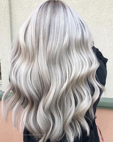Woman with waist-length silver blonde waves