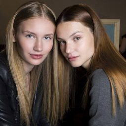 two women with long straight hair
