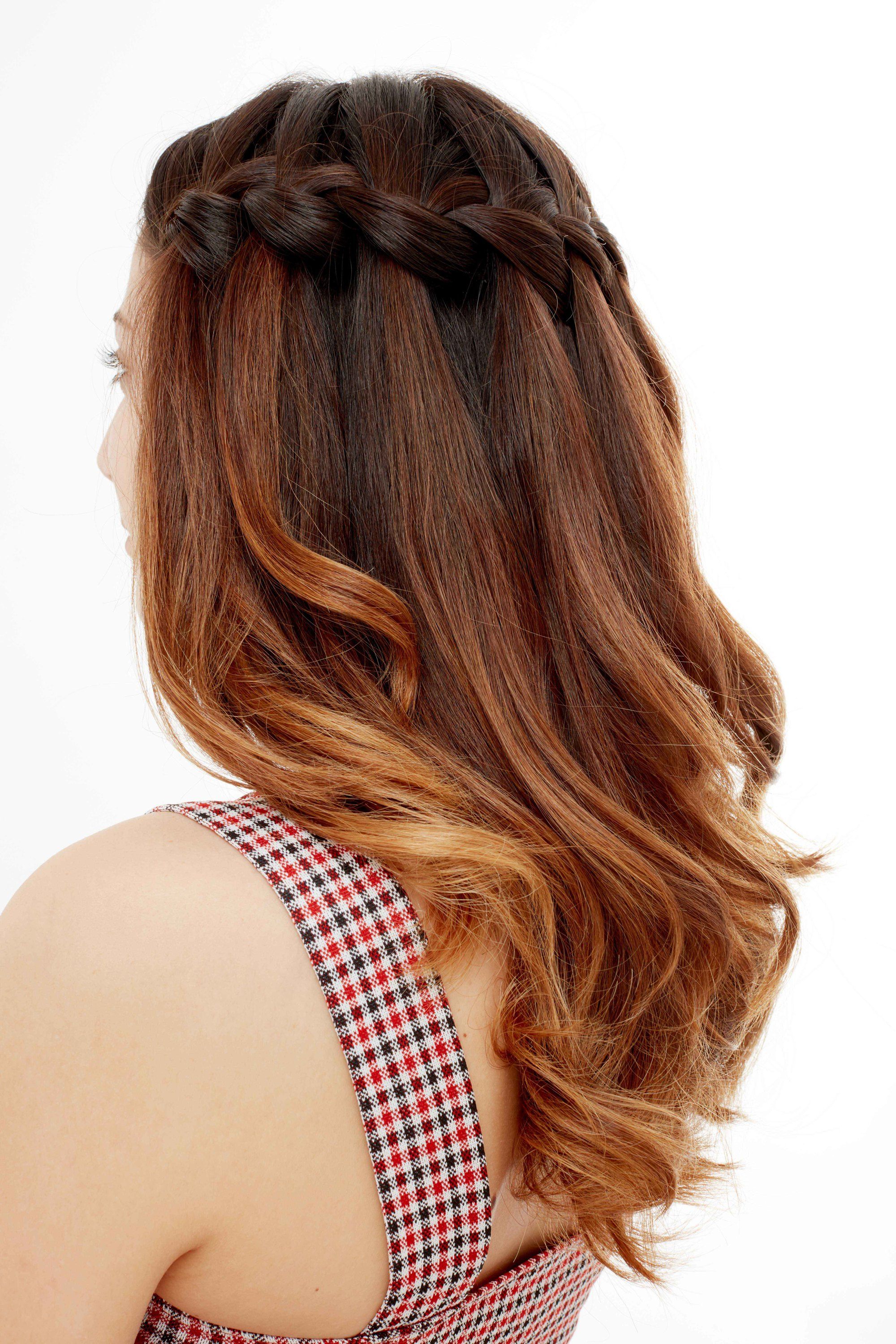 Woman with red brown ombre hair in a waterfall braid