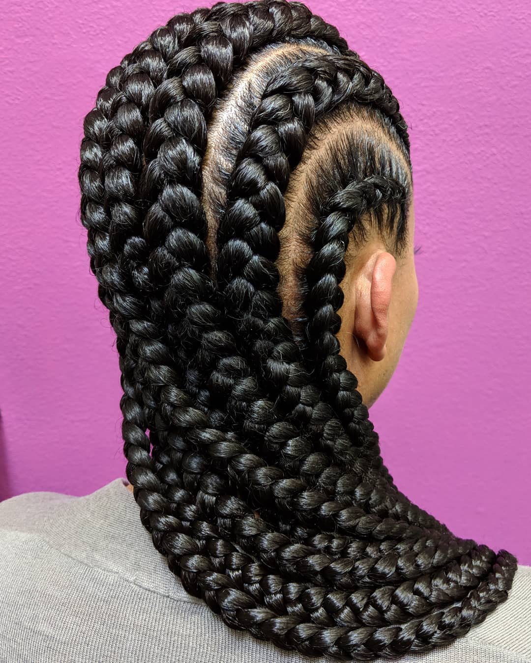 Woman with very big and long dark straight back cornrows